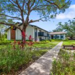 Two-Bedroom Apartments in Winter Park, FL - The Taylor - Outdoor Walkway with Greenery and Sidewalk